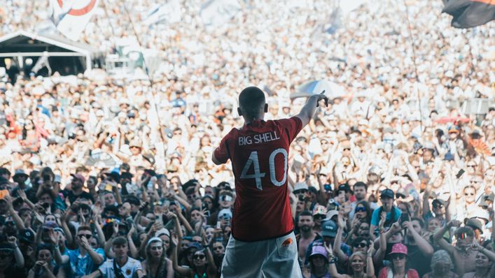 Aitch gave fans a look at the new Manchester United home shirt as he performed at Glastonbury