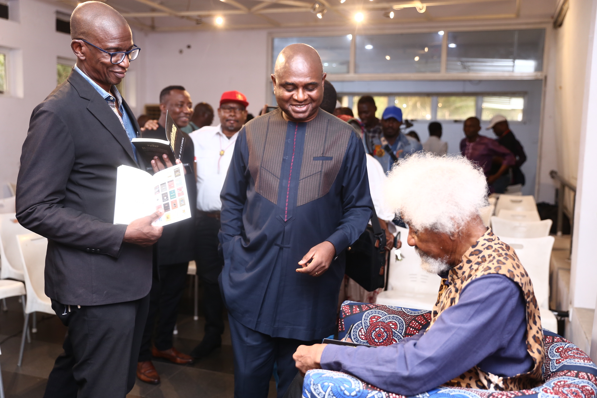 Soyinka signing his autograph