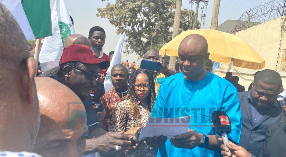 Representative of NAFDAC DG, Deputy Director of Human Resource, Adeyemi Omolehin receives the letter of demand from protesting TUC members